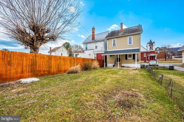 back of house with a lawn