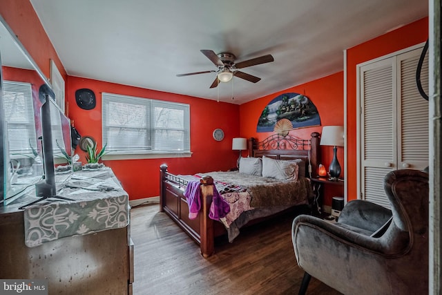 bedroom with ceiling fan, wood-type flooring, and a closet