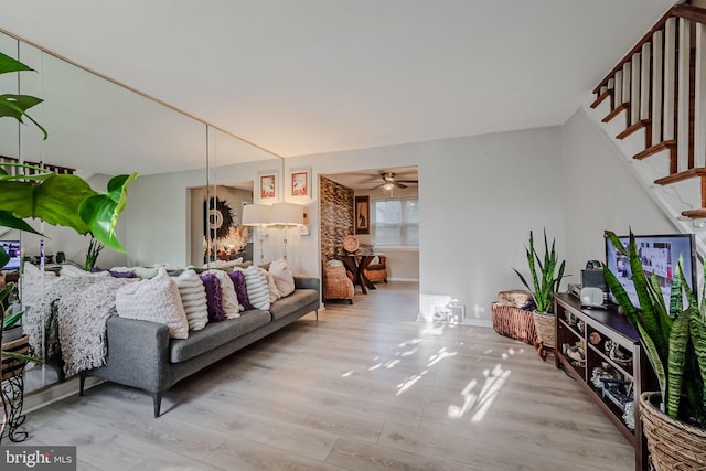 living room with ceiling fan and light hardwood / wood-style flooring