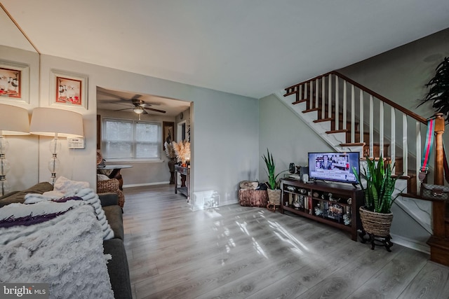 living room featuring hardwood / wood-style flooring and ceiling fan