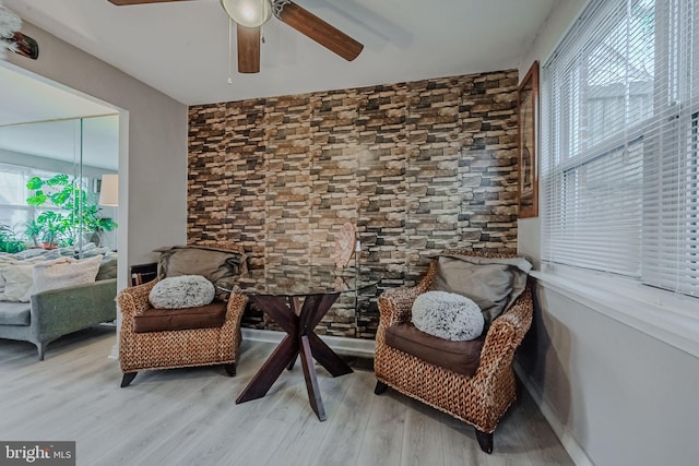 sitting room with a wealth of natural light, hardwood / wood-style floors, and ceiling fan