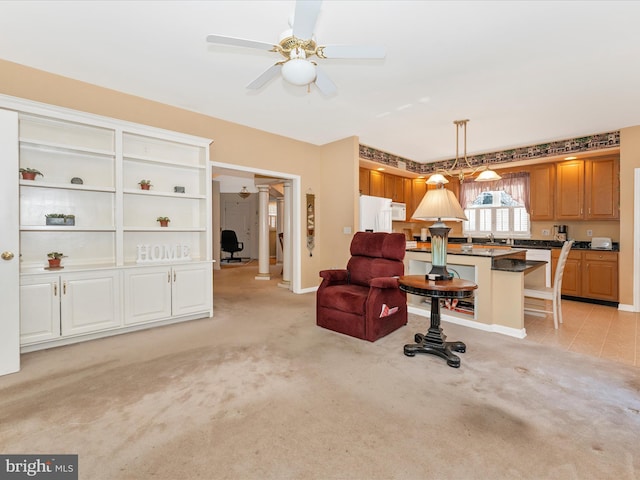 carpeted living room with sink and ceiling fan