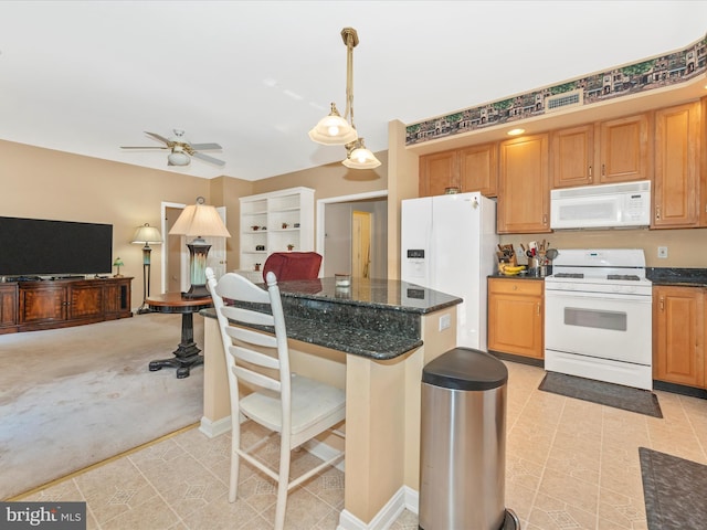 kitchen with pendant lighting, dark stone countertops, a breakfast bar area, ceiling fan, and white appliances