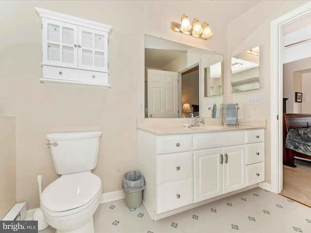 bathroom with vanity, tile patterned flooring, and toilet