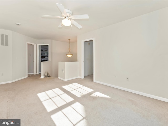 empty room with ceiling fan and carpet flooring