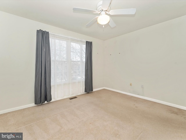 carpeted empty room featuring ceiling fan