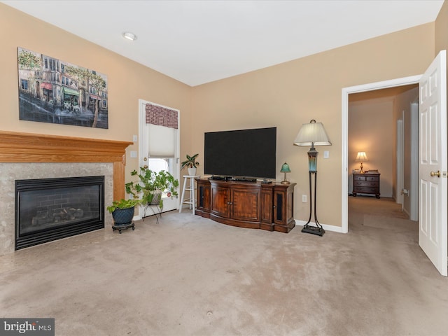 carpeted living room featuring a premium fireplace