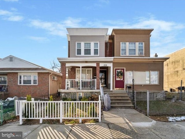 townhome / multi-family property featuring covered porch