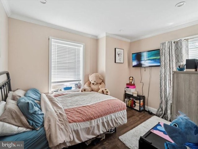 bedroom with dark hardwood / wood-style flooring and ornamental molding