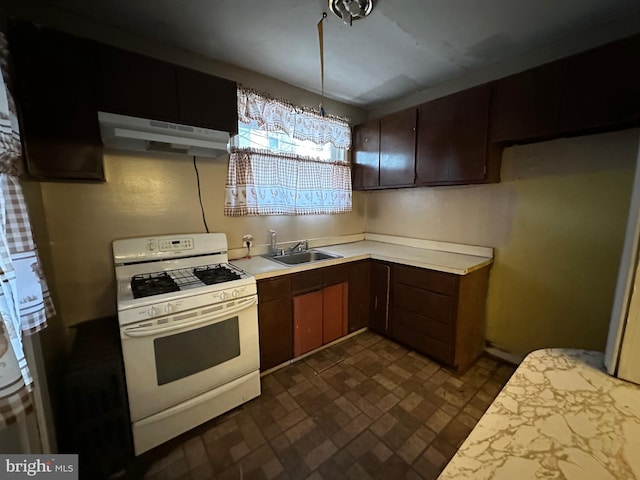 kitchen featuring sink and white gas range oven