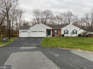 ranch-style house with a front lawn and a garage