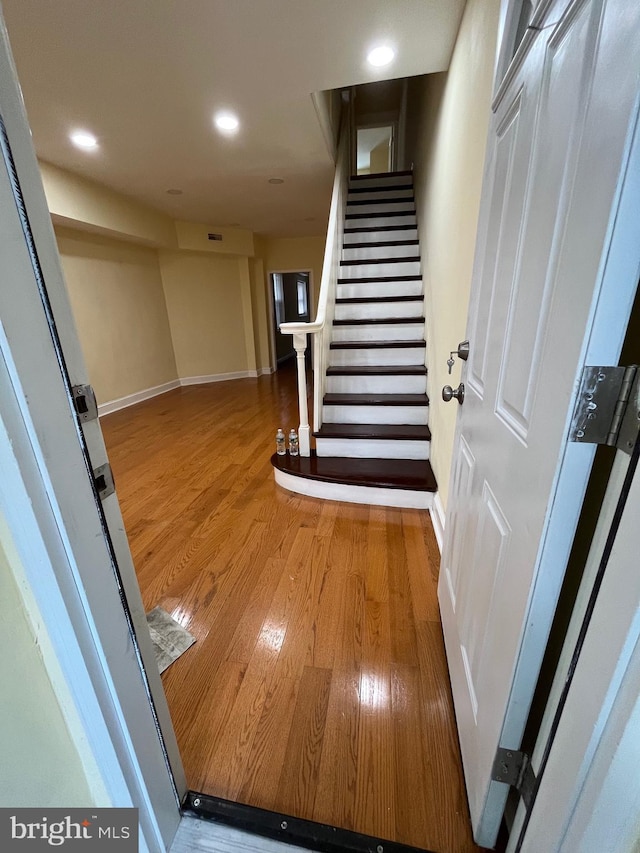 staircase featuring hardwood / wood-style floors