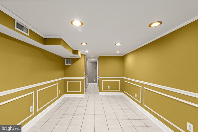 basement with crown molding and light tile patterned floors