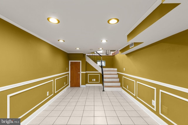 interior space with light tile patterned floors and crown molding