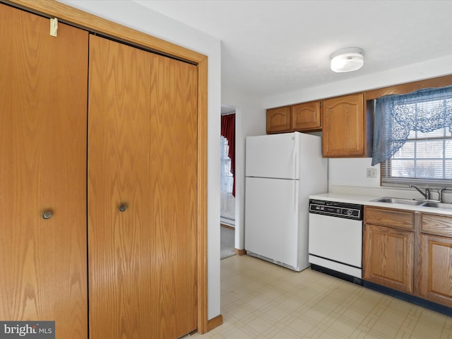 kitchen with sink, white appliances, and baseboard heating