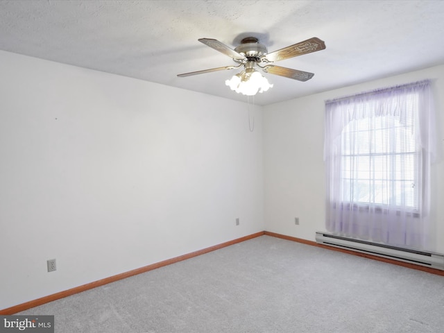 spare room with ceiling fan, a healthy amount of sunlight, baseboard heating, and carpet flooring