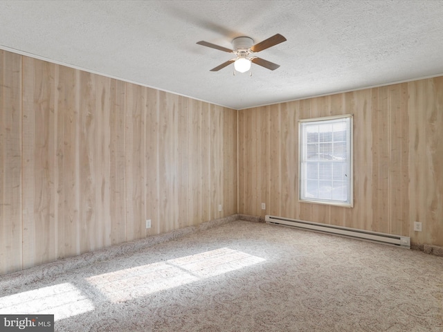 spare room with ceiling fan, a textured ceiling, and baseboard heating