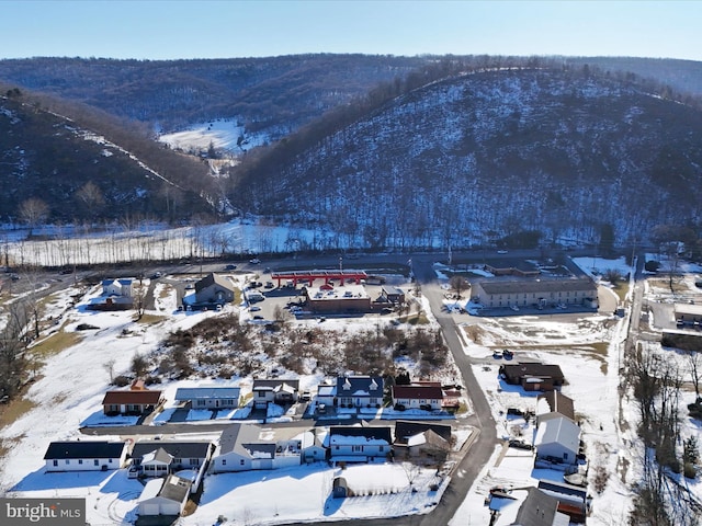 snowy aerial view featuring a mountain view