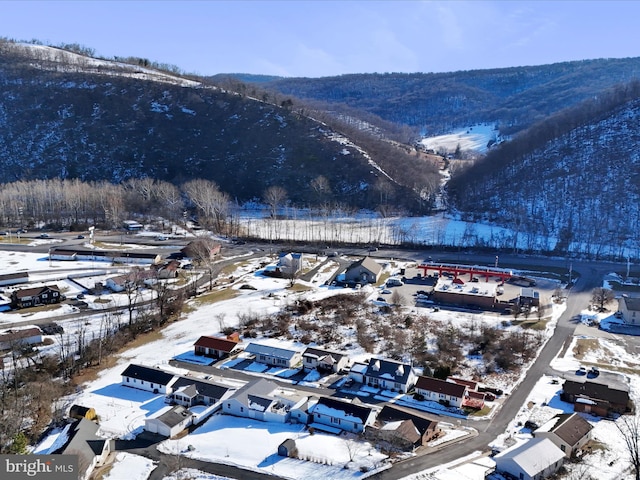 snowy aerial view with a mountain view