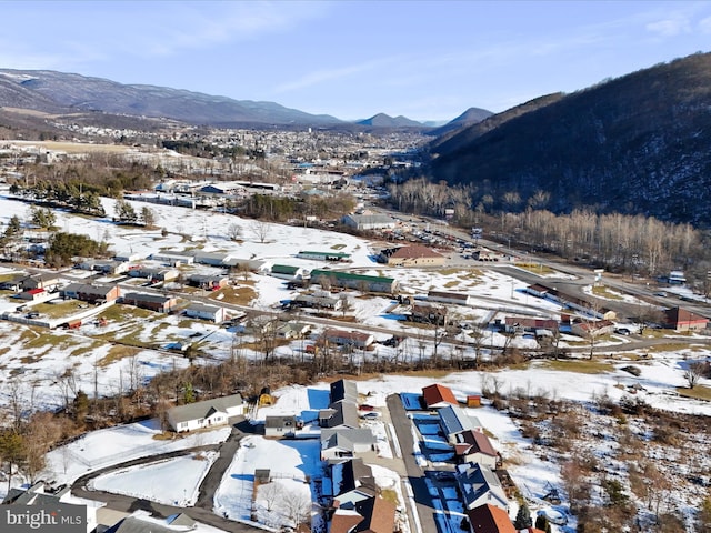 snowy aerial view featuring a mountain view