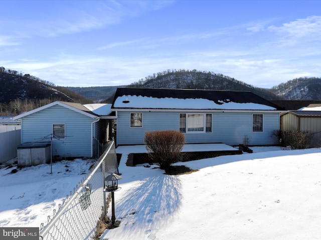 view of front of house featuring a mountain view and a shed