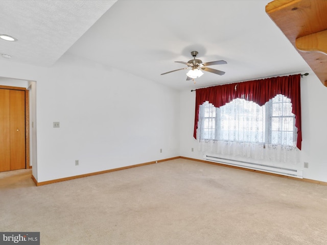 empty room featuring a baseboard radiator, carpet, and ceiling fan