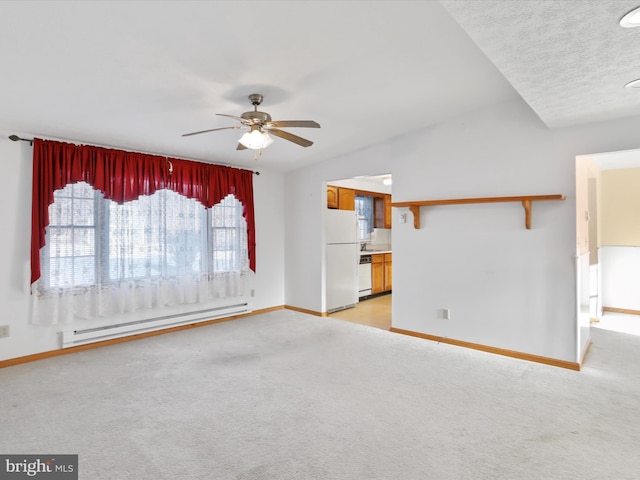 unfurnished living room with vaulted ceiling, a textured ceiling, baseboard heating, ceiling fan, and light colored carpet