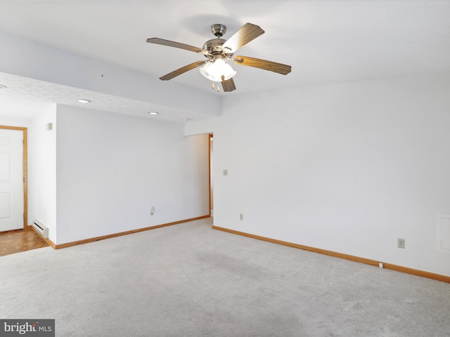 unfurnished room featuring ceiling fan, a baseboard radiator, and light carpet