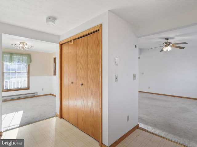 hallway with a baseboard radiator and light carpet