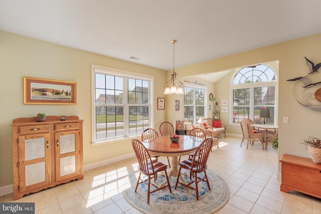 dining room with an inviting chandelier, light tile patterned floors, and a healthy amount of sunlight