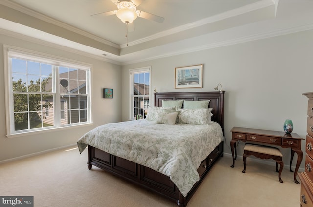 bedroom with a raised ceiling, ornamental molding, light colored carpet, and ceiling fan