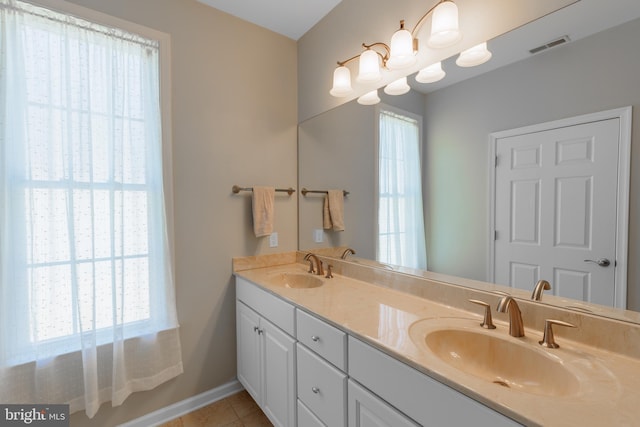 bathroom featuring vanity, tile patterned flooring, and a notable chandelier