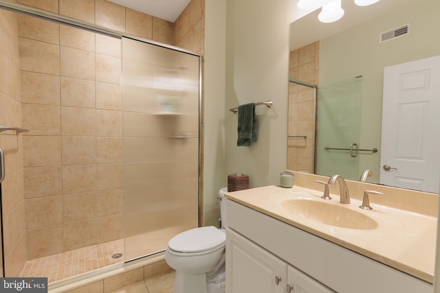 bathroom with vanity, a shower with shower door, and toilet