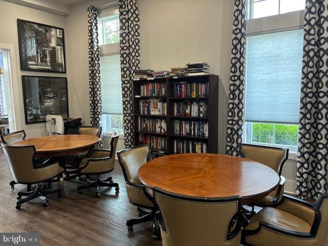 dining area with wood-type flooring and a healthy amount of sunlight