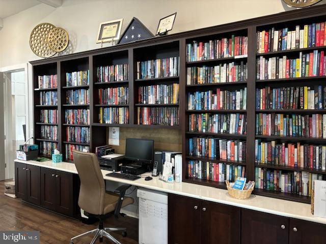 office featuring dark hardwood / wood-style floors and beam ceiling