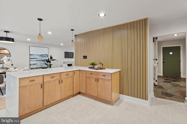 kitchen featuring decorative light fixtures and light brown cabinets