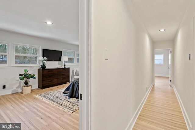 corridor with light hardwood / wood-style floors