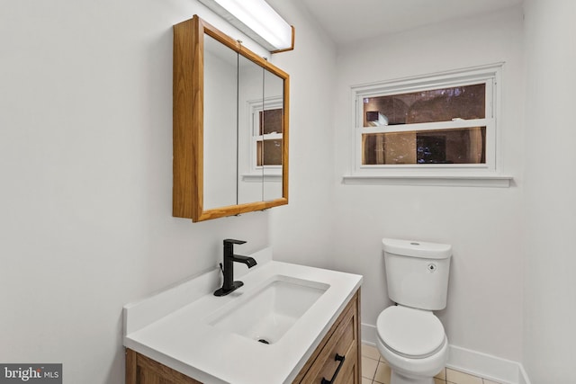 bathroom featuring tile patterned flooring, vanity, and toilet