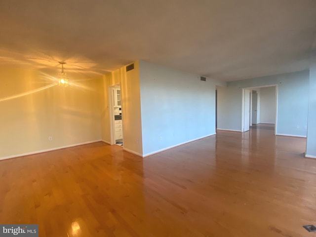 empty room with hardwood / wood-style flooring