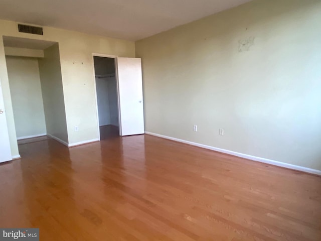 unfurnished bedroom with a closet and hardwood / wood-style floors