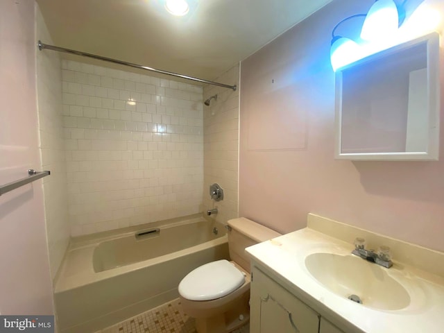 full bathroom with tile patterned flooring, tiled shower / bath combo, toilet, and vanity