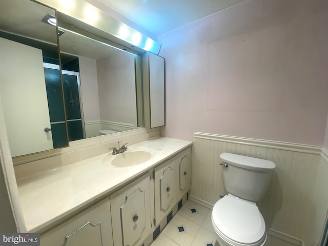 bathroom with tile patterned floors, vanity, and toilet