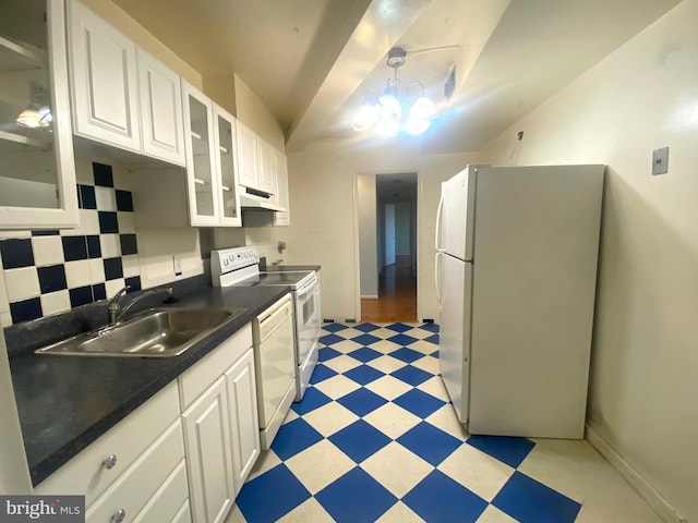 kitchen with sink, white cabinets, white appliances, and an inviting chandelier