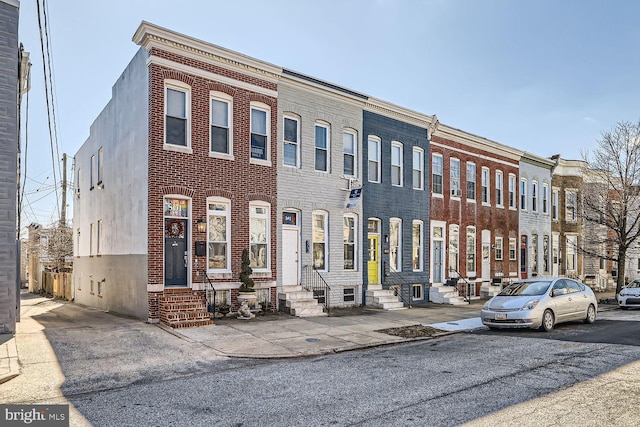 view of front facade with entry steps and brick siding