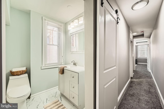 bathroom with marble finish floor, baseboards, vanity, and toilet