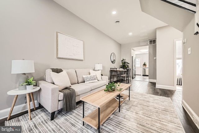 living room with recessed lighting, wood finished floors, visible vents, and baseboards