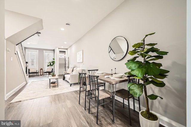 dining room with light wood finished floors, baseboards, visible vents, and recessed lighting