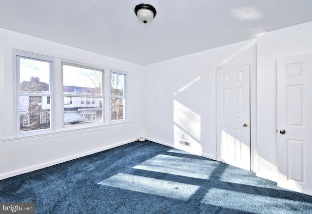 interior space featuring dark carpet