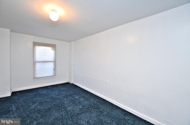 empty room featuring dark carpet