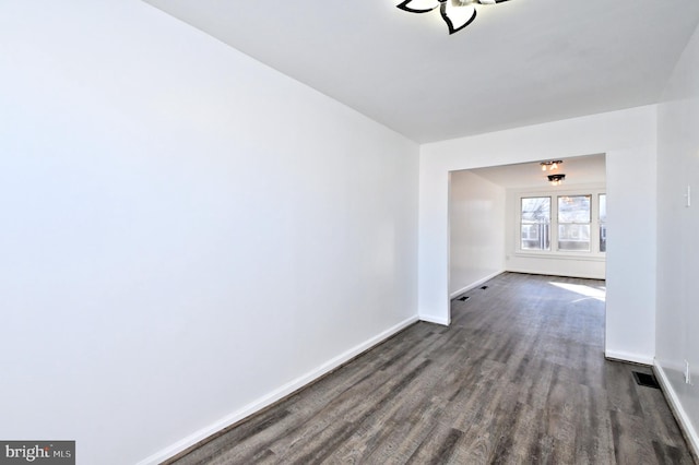 unfurnished room featuring dark hardwood / wood-style flooring